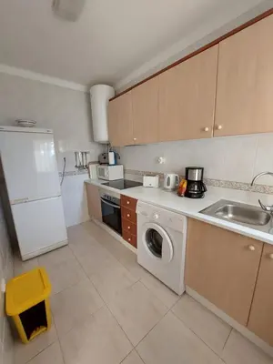 a kitchen with a white refrigerator and a dishwasher at Apartamento Sunny Velamar in Patroves