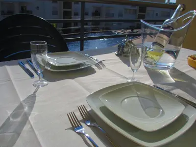 a table with a plate and wine glasses on it at Encosta Da Orada by Garvetur in Albufeira