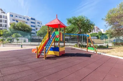 a playground with a slide and a play structure at Jardins Santa Eulalia by Garvetur in Albufeira