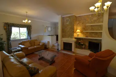 a living room with a couch and a fireplace at Bonita in Quarteira