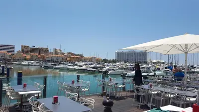a woman standing on a deck near a marina at Quinta Do Romão in Vilamoura