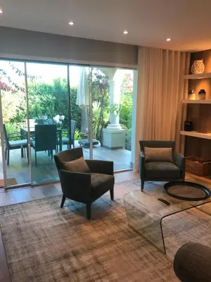 a living room with two chairs and a table at Vila Balaia - Luxury Boutique Villas in Albufeira