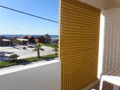 a yellow facade of a building with a view of a street at Aeromar Beach Hotel in Faro