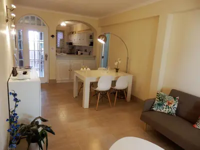 a living room and kitchen with a table and chairs at Apartment Amalia in Albufeira