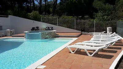 a row of lounge chairs next to a swimming pool at Apartment Amalia in Albufeira