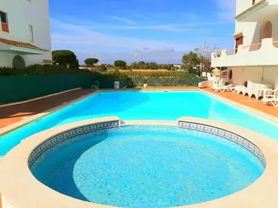 a large swimming pool in front of a house at Apartment Amalia in Albufeira