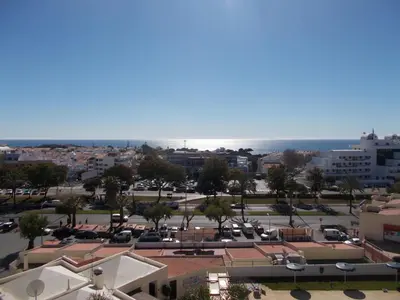 a view of a city with the ocean in the background at Bellavista Apartments in Albufeira