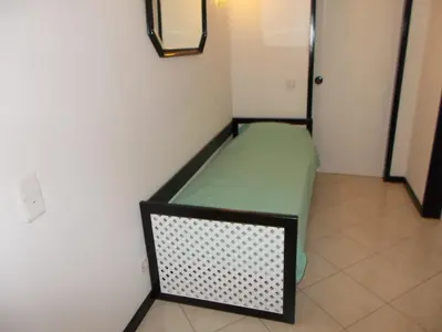 a small room with a green bed in the corner at Bellavista Apartments in Albufeira
