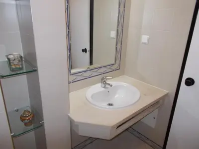 a bathroom with a sink and a mirror at Bellavista Apartments in Albufeira