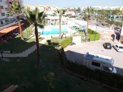 an aerial view of a resort with a pool and palm trees at Bellavista Apartments in Albufeira