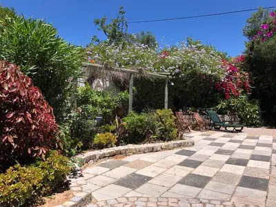 a garden with a bench and some plants and flowers at Genies Villa Boutique Algarve in Almancil
