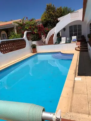 a swimming pool with blue water in a house at Genies Villa Boutique Algarve in Almancil