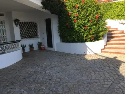 a house with a large bush with red flowers at Genies Villa Boutique Algarve in Almancil