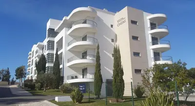 a white building with balconies on the side of it at Vista das Ondas - AP in Albufeira