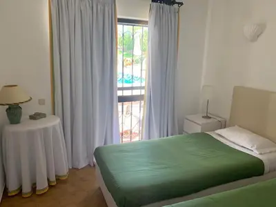 a bathroom with a yellow toilet and a sink at Casa Camelia in Vilamoura
