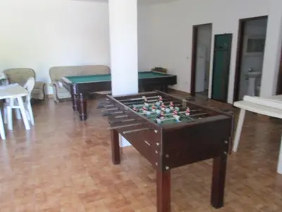 a living room with a foosball table and tables at Vivendas Costa in Barros da Fonte Santa
