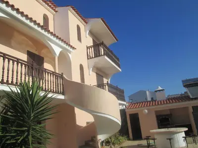 a building with a spiral staircase in a courtyard at Vivendas Costa in Barros da Fonte Santa