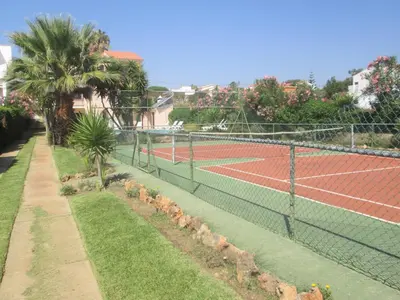 a tennis court with two tennis courts at Vivendas Costa in Barros da Fonte Santa