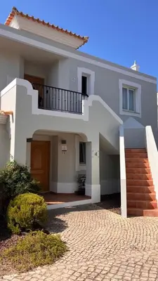 a white house with a staircase in front of it at Quinta do Lago - Apartamento Salinas in Quinta do Lago
