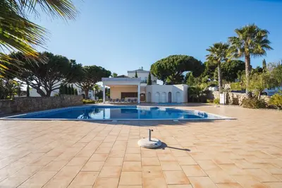 a swimming pool in front of a house at Quinta do Lago - Apartamento Salinas in Quinta do Lago