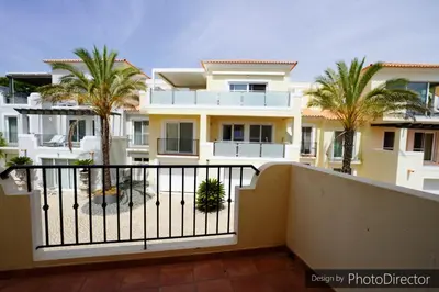 a view from the balcony of a house with palm trees at Quinta do Lago - Apartamento Salinas in Quinta do Lago