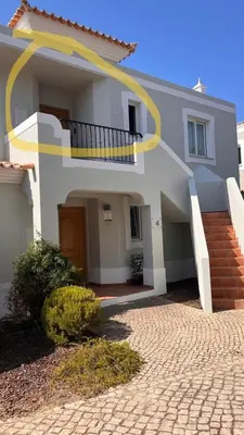 a large white house with a staircase in front of it at Quinta do Lago - Apartamento Salinas in Quinta do Lago