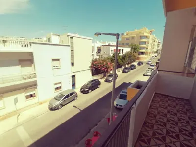 a view of a city street with cars parked on a balcony at Apartamento S. Luis in Faro