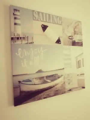 a picture of a boat hanging on a wall at Apartamento S. Luis in Faro
