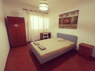a small bedroom with a bed in a room at Apartamento S. Luis in Faro