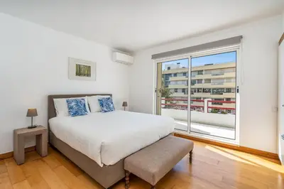 a bedroom with a bed and a large window at Marina Vilamoura Relax in Vilamoura