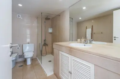 a bathroom with a toilet and a sink and a shower at Marina Vilamoura Relax in Vilamoura