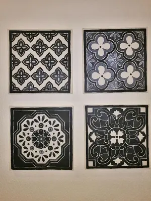 four framed prints of flowers on a wall at Apartamento Penha in Faro