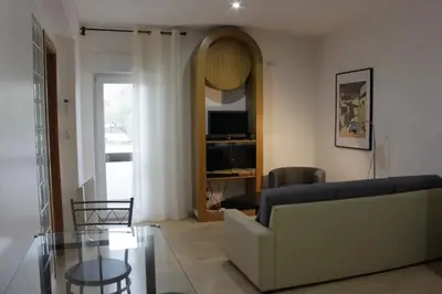 a living room with a couch and a glass table at 5 Minutes Walk from the Beach in Albufeira