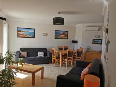 a living room with a couch and a table at Olhos de Água Apartment Albufeira in Albufeira