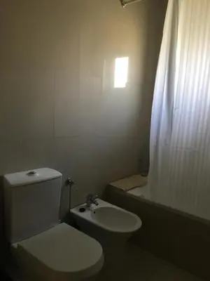 a bathroom with a toilet and a sink and a tub at Apartamento Vilamoura Marina in Vilamoura