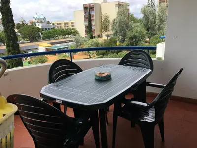 a black table and chairs on a balcony at Apartamento Vilamoura Marina in Vilamoura