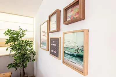 a wall with three picture frames and a sign on it at Faro Central - Holiday Apartments in Faro