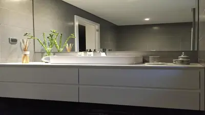 a bathroom with a white sink and a mirror at NOA Apartment Quinta do Lago in Quinta do Lago