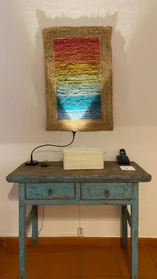 a desk with a colorful painting on the wall at Quinta do Lago Golf in Quinta do Lago