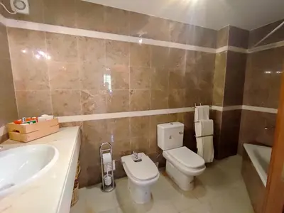 a bathroom with a toilet and a sink at Vila Magna near The Strip with BBQ, AC, Balcony, Parking, 4 TVs and Free wifi in Albufeira