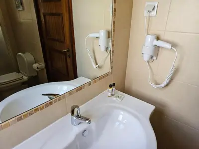 a bathroom with a white sink and a mirror at São Rafael Golden Pearl Haven in Albufeira