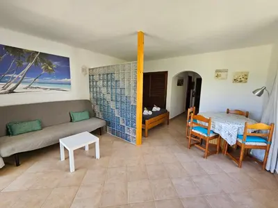 a living room with a couch and a table at São Rafael Golden Pearl Haven in Albufeira