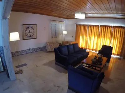 a living room with two couches and a table at Vila Ninita in Vilamoura