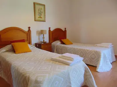 a bedroom with two beds with towels on them at Vila Ninita in Vilamoura