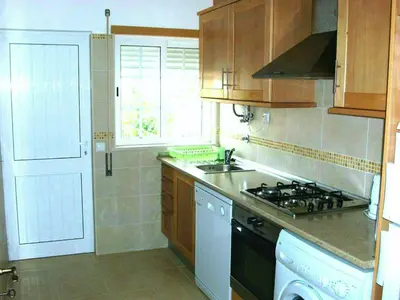 a kitchen with a stove and a sink and a window at Jazzy Cool Apartment Near White Sand Beaches in Albufeira