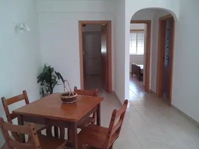 a dining room with a wooden table and chairs at Deluxe Apartment E in Albufeira