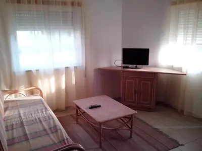 a living room with a couch and a tv at Deluxe Apartment E in Albufeira