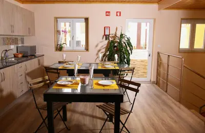 a kitchen with a table and chairs in a room at Happy House in Faro