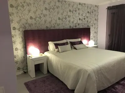a bedroom with a large white bed with two lamps at Timeless Vacations Vilamoura Marina Flat WIFI & Pool in Vilamoura