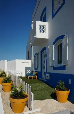a blue building with plants inront of it at Golden Cliff House in Albufeira